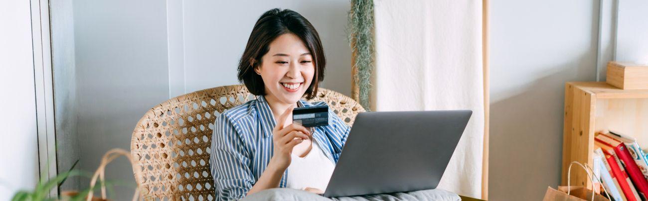 a woman sitting at a table using a laptop