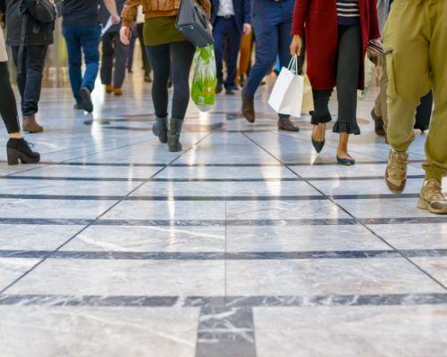 a group of people walking on a sidewalk