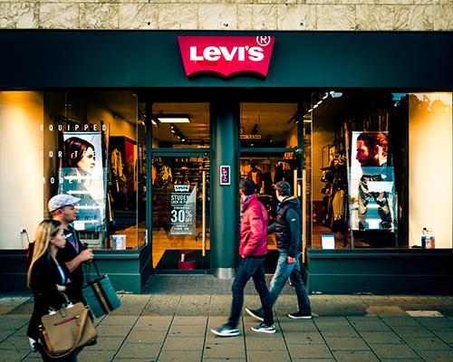 a group of people walking in front of a store