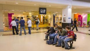 The Gap storefront with teenagers out front