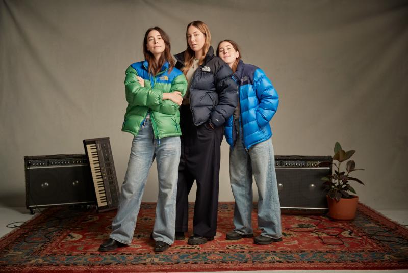 a person standing in front of Danielle Haim et al. posing for the camera